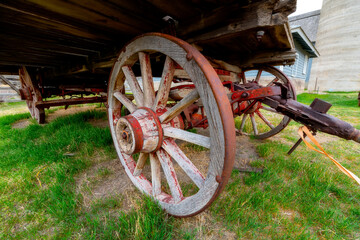 Close up of a wagon wheel beneath a flatbed