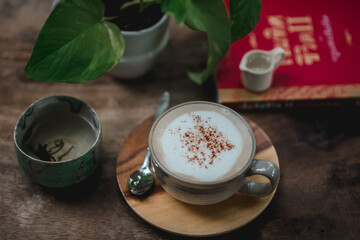 hot coffee cappuccino laid on a wooden background