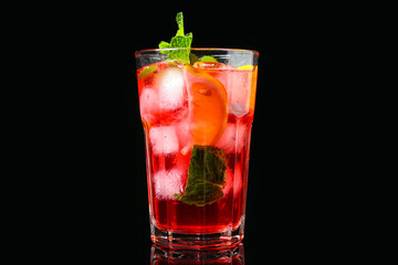 Glass of tasty ice tea with lemon on dark background