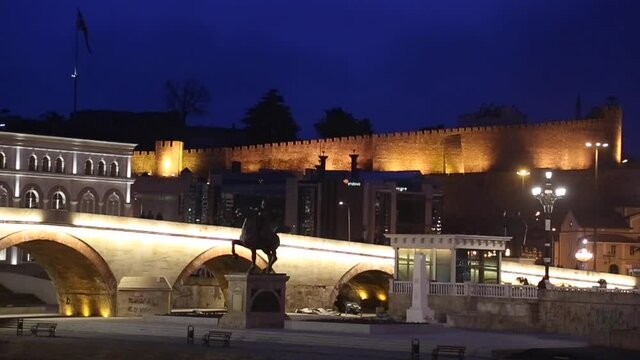 Stone Bridge at night and behind Skopje Castle in Macedonia. The bridge is considered a symbol of Skopje.