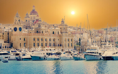 Beautiful scene of the famous Marina Museum of Malta and the harbor dockland illuminated by the sunset in the summertime