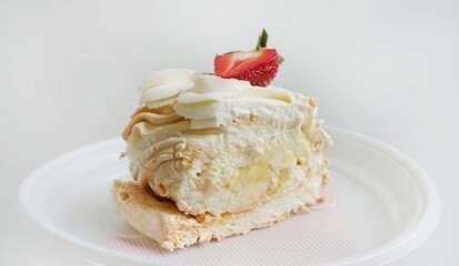 food dessert portion cut meringue roll with strawberries and butter cream