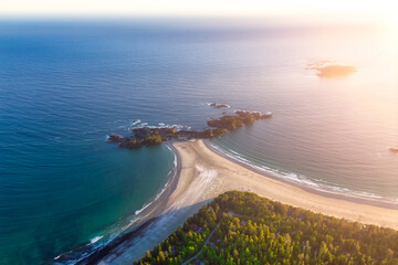 Aerial Canadian Landscape at the West Pacific Ocean Coast during a bright colorful vibrant sunset. Taken from Airplane in Tofino, Vancouver Island, British Columbia, Canada.