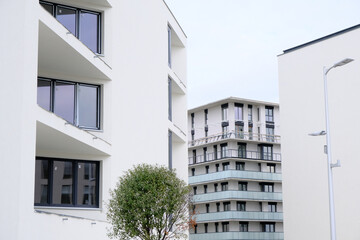 Exteriors of new modern white apartment buildings with balcony in contemporary residential district.