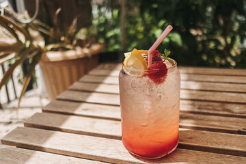 Italian soda syrup of mixed berries and lemon served on wooden desk in summer.