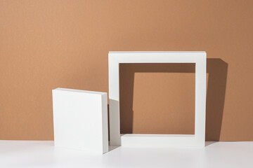 White podiums for presentations on a brown background. Top view, flat lay