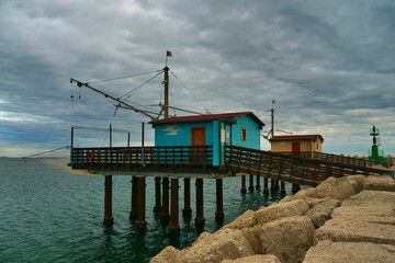 Fototapeta premium Winter sea with view of traditional italian wooden fishing houses, Fano, Italy.