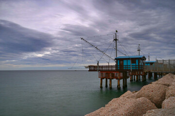 Winter sea with view of traditional italian wooden fishing houses, Fano, Italy.