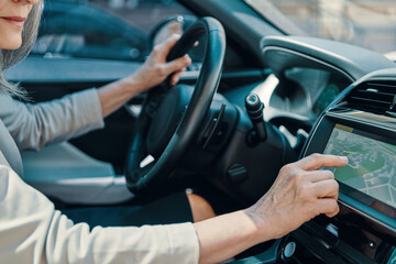 Close up of woman using global positioning system while driving car
