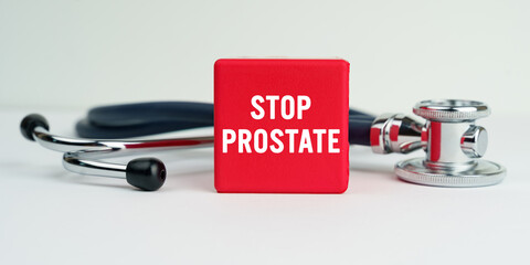 On the table is a stethoscope and a red cube with the inscription - STOP PROSTATE