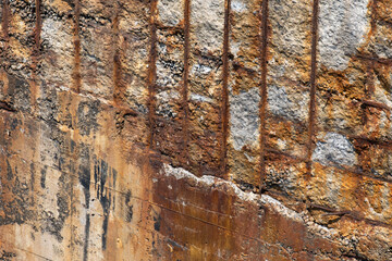 old damaged and weathered weathered concrete with rusty iron rods