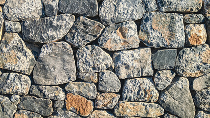 stone wall texture.

Abstract texture of stones large and small rocky wall, side view close-up.