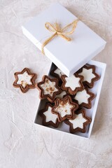 Chocolate cookies with cream packed in a white box, light background, copy space, holiday Chocolate Day, Christmas