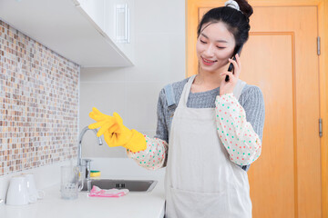 Asian girl cleaning the kitchen