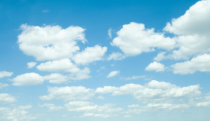 Blue sky with white fluffy clouds, perfect sunny day background
