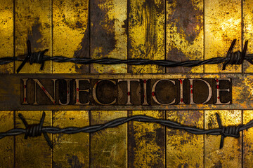Injecticide text formed with blood splattered authentic typeset letters on vintage textured silver grunge copper and gold background with lined with barbed wire