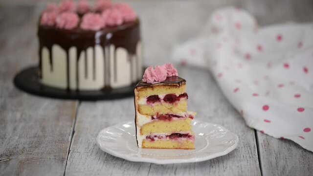 Piece of homemade vanilla cherry cake with cream.