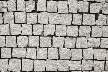 Overhead view of cobblestone street texture. Stone pavement texture