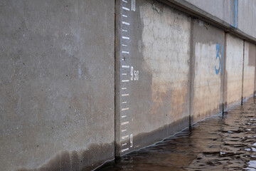 Water level measurement gauge during flood. depth marker on the wall. Water level scale in the...
