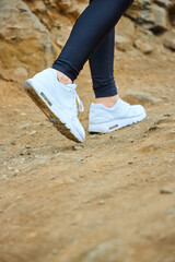 woman in white sneakers in the mountain