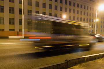 Fototapeta na wymiar The movement of a blurred minibus along the overpass in the evening.