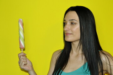 Profile half face portrait with copy space empty place for advertisement of naughty seductive girl want eat ice cream gesturing showing tongue out isolated on yellow background