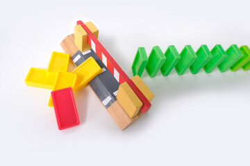 close-up of a line of dominoes falling, colored cubes of dominoes falling one by one, the concept...