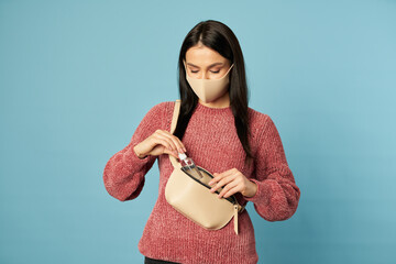 Young woman taking out a bottle of antiseptic from her bag