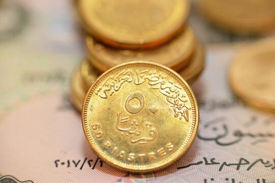 The reverse side of Egyptian 50 fifty piasters 2021 AD, 1442 AH, on a blurred 50 piasters coinage and fifty piasters background, circulating Egyptian coins money background close up view
