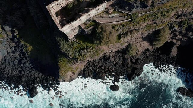 Flying above the ruin of Casa Hamilton located on a cliff near the sea - Los Realejos