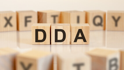 dda - Doha Development Agenda - letters on wooden cubes on white background