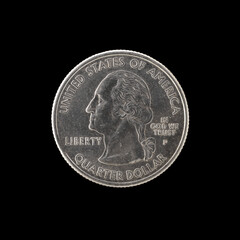 quarter of a US dollar coin isolated on black background