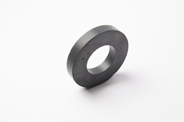 Circular black ferrite ring magnet isolated on a white background