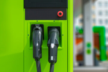 Green electric car charging at power station. Eco-friendly filling station for eco car.