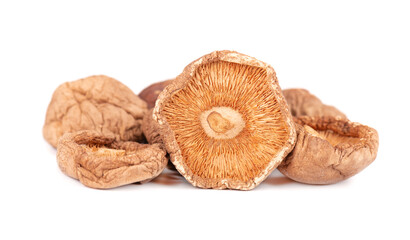 Dried shiitake mushrooms, isolated on white background. Japanese forest mushroom. Lentinula edodes. Close up.