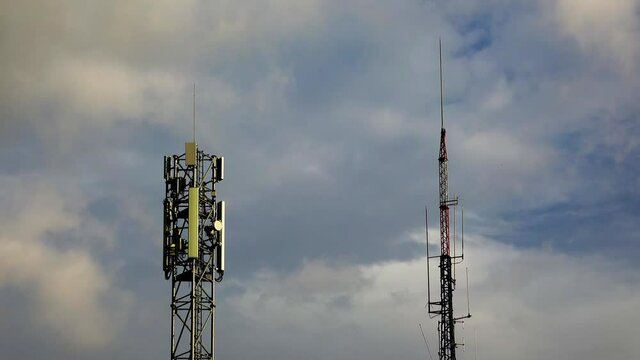 The tops of the two radio towers are modern 5G and outdated for radio signal transmission.