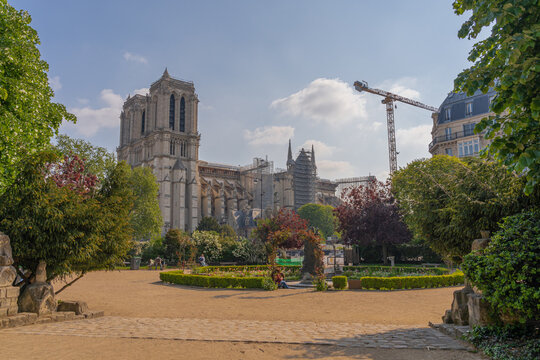 Paris, France - 05 02 2021: View of Notre-Dame from Square Rene Viviani Picturesque park near historic church
