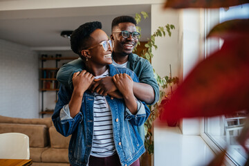 Black couple in love laughing at home