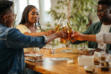 Excited friends toasting with beer glasses