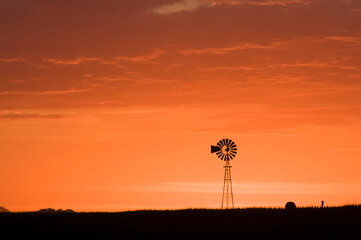 Fototapeta na wymiar Windmill in countryside at sunset, Pampas, Patagonia,Argentina.