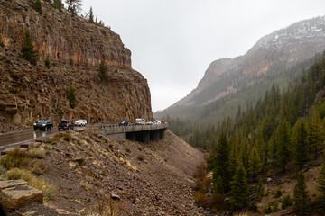Yellowstone, Wyoming, USA, May 24, 2021: Tourist driving on the Golden Gate Viaduct on the Grand...