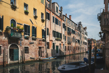 Fototapeta na wymiar Canal between Venetian houses in Venice, Italy