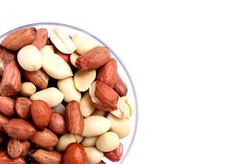 Peanut butter isolated and peanuts in the peel scattered on the white background. Copy space.