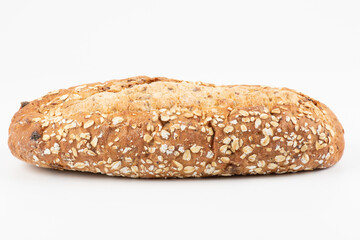 whole grain bread on the white background.  healthy food. Whole oval loaf of wheat unleavened bread with bran on a white background