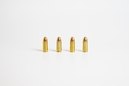 four gold bullets standing with a white background