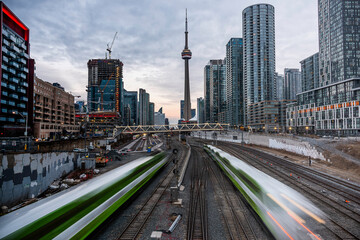 Commuter Go Trains leaving union station. This is shot during the sunset golden hour peirod. 