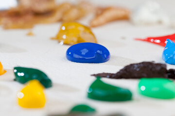 oil and acrylic paints in blue, red and other colors
