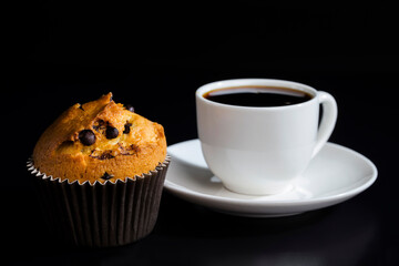 a delicious fresh bun and a cup of black aromatic coffee