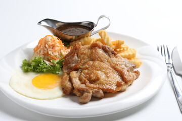 grilled golden bbq meat chicken cop pork cutlet beef steak with fried egg, French fries, coleslaw salad and black pepper sauce in pot western cuisine menu
