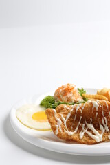 deep fried golden crispy fish fillet and chips with fried egg, French fries, coleslaw salad in tartar sauce western cuisine menu